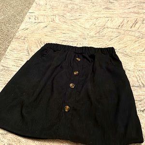 Black skirt with tan buttons and pockets